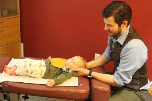 dr. guzik adjusting a young child